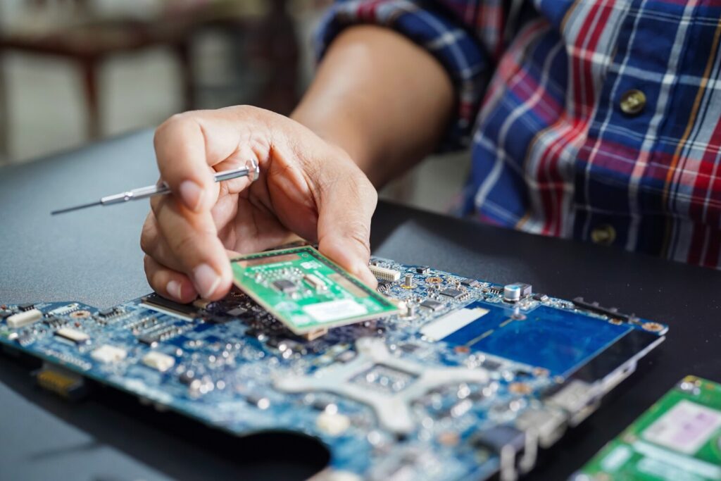 asian technician repairing micro circuit main board computer 39768 1233