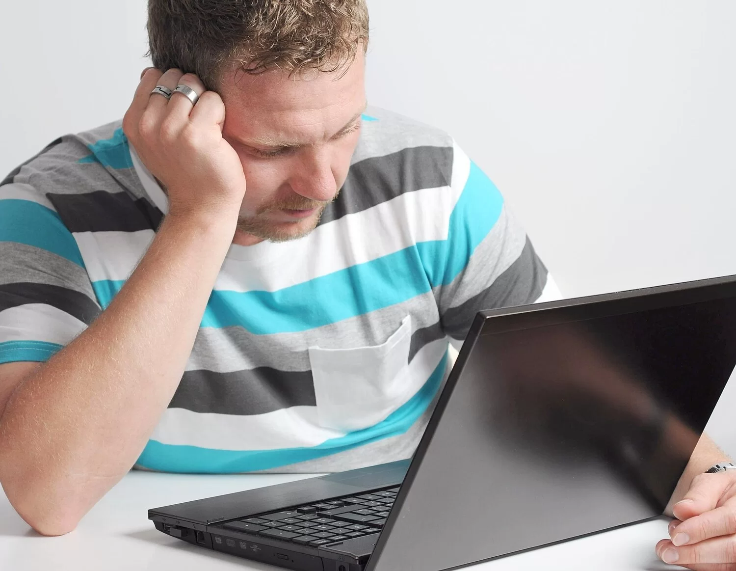 worried man using laptop while sitting table white background 1048944 29612056
